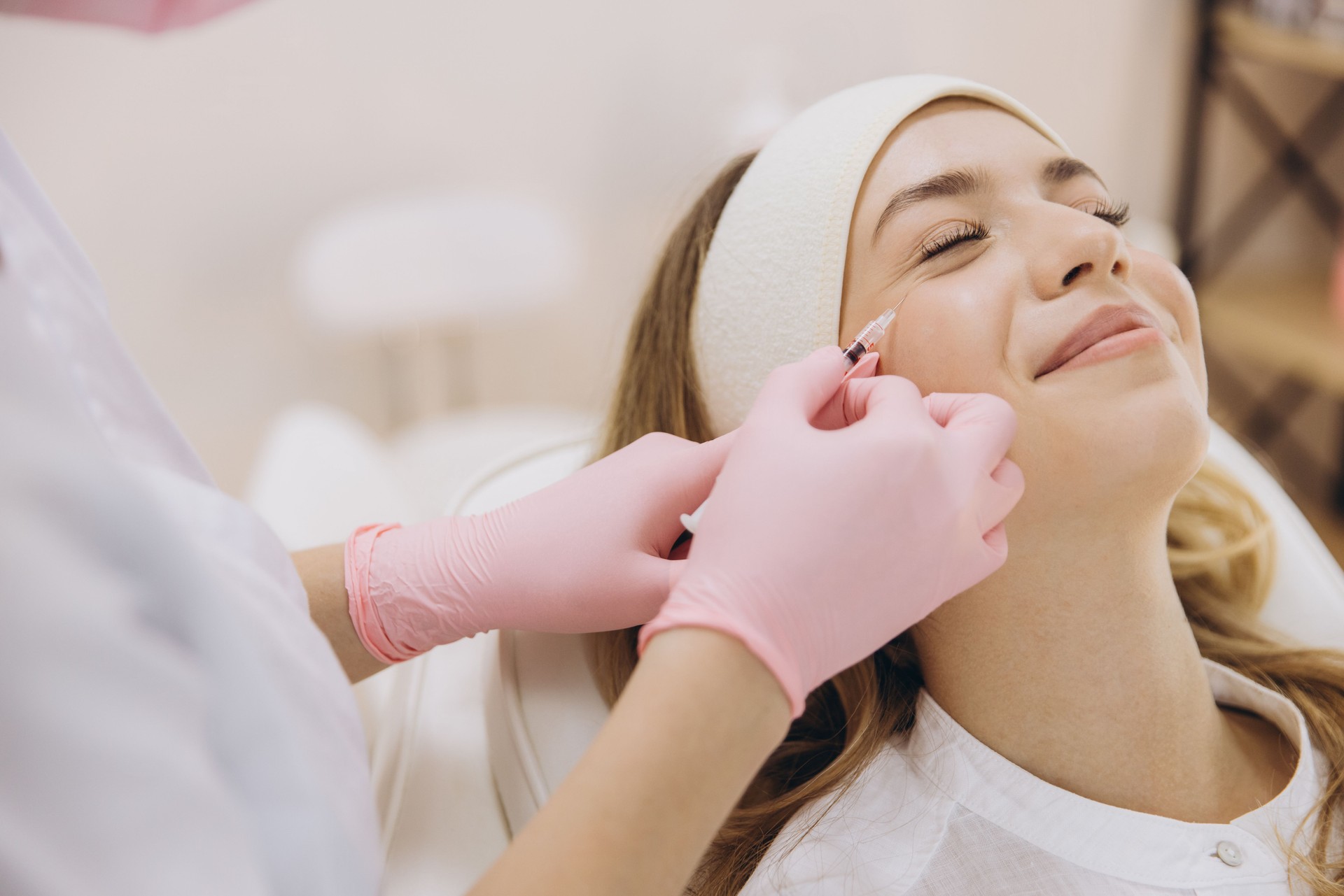Cosmetologist administering anti aging injections on a relaxed woman's face in a beauty salon, enhancing skin vitality and confidence